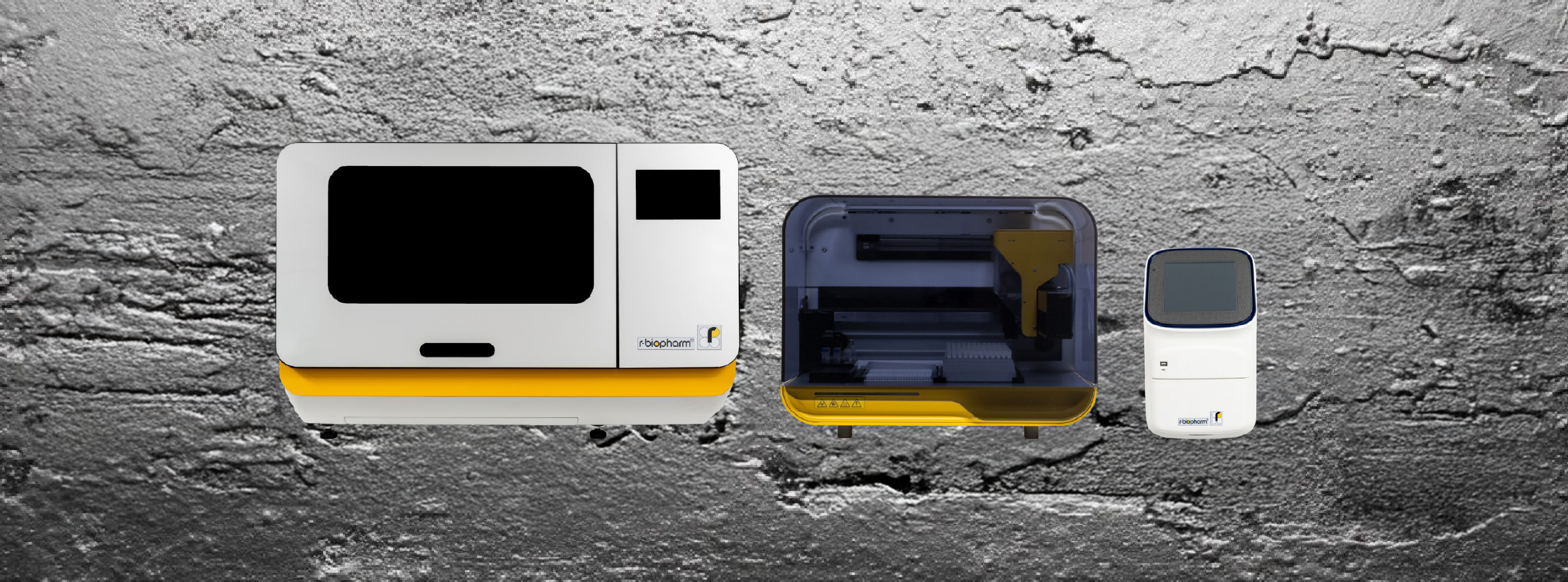 three machines of various sizes displayed on a grey background