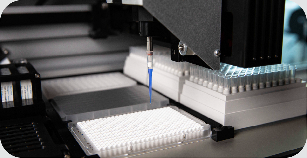 the internals of a complex piece of medical instrumentation, showing pipettes delivering liquid to a reagent plate