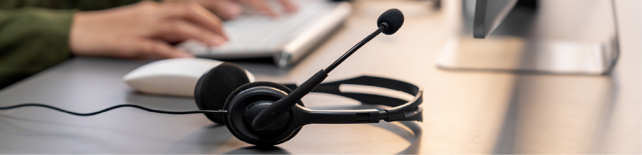 a headset with a microphone sitting on a desk in a call centre