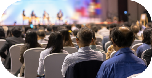a group of people sitting in an audience for a lecture or seminar being delivered to them