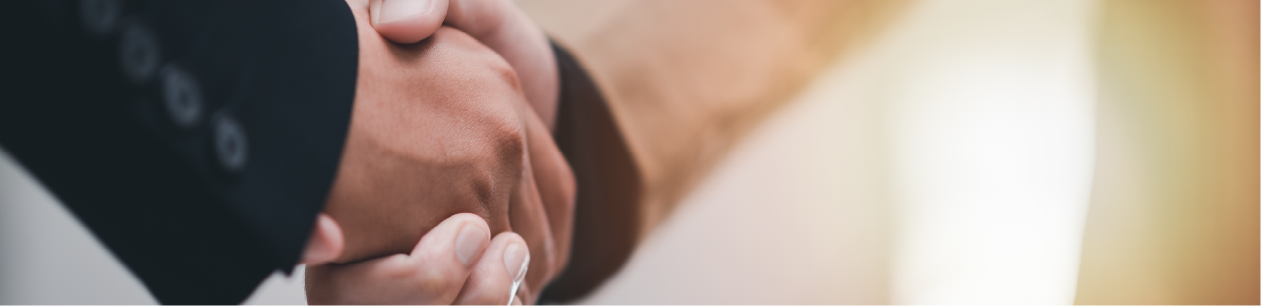 a closeup of two hands shaking symoblising a business deal between R-Biopharm Australia partners