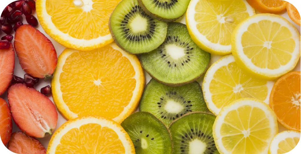 sliced strawberries, oranges, kiwi fruit, lemons and more arranged together
