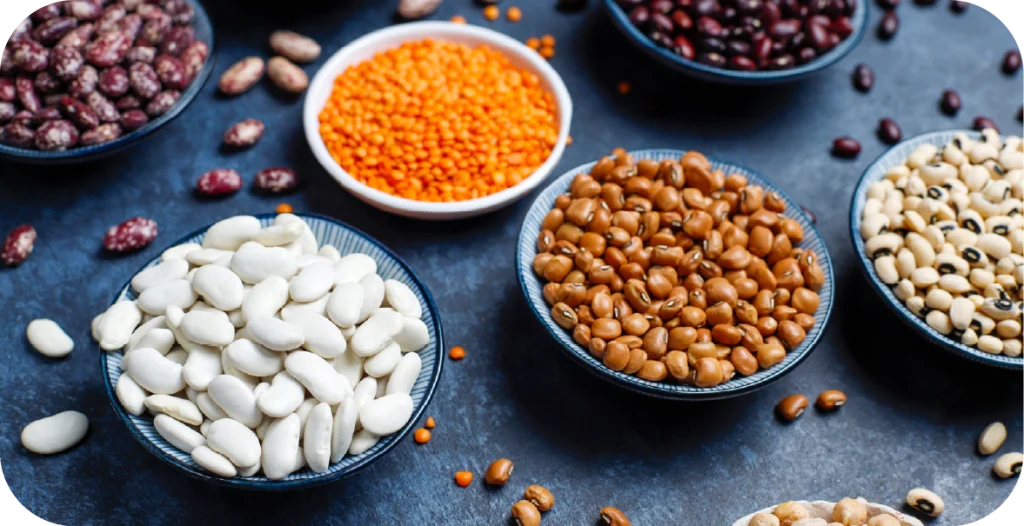 grains and legumes in bowls on a black table