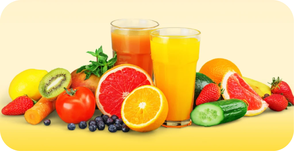 2 glasses of fruit juice surrounded by fresh fruits set on a yellow background
