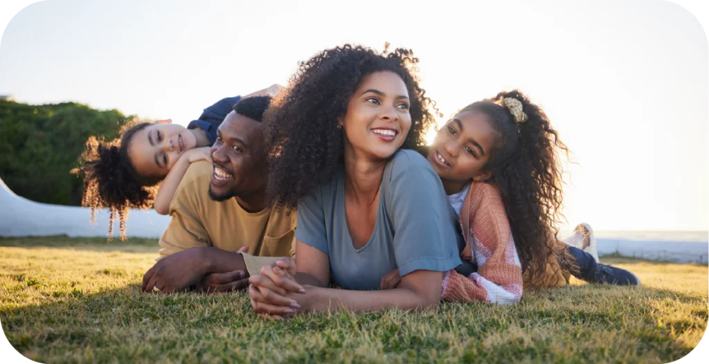 a young family lying together on the grass