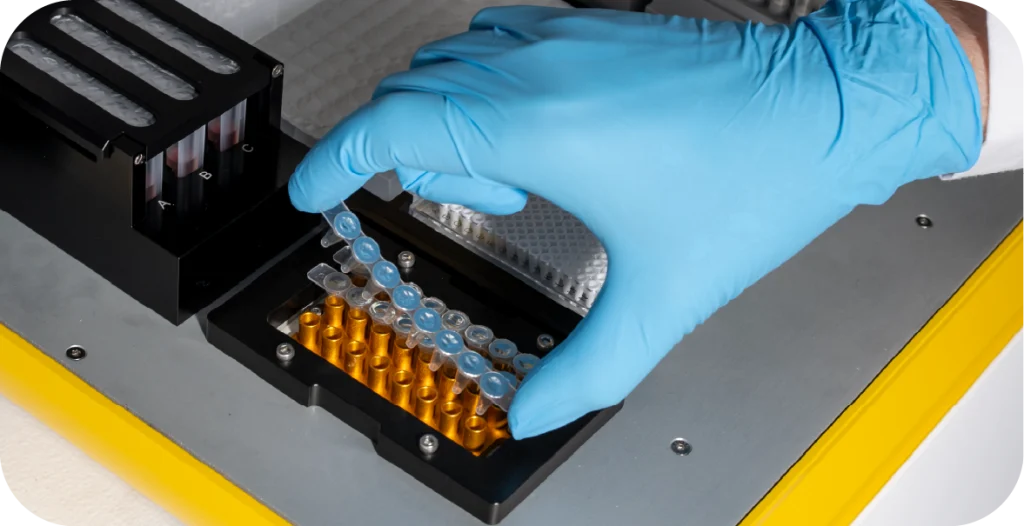 A scientist places a row of tubes into a RIDA®Xplore machine