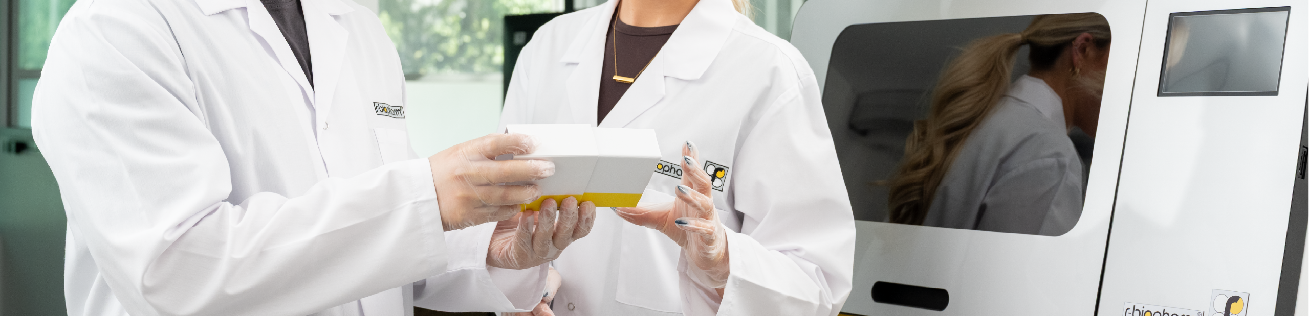 two scientists standing next to a RIDA®Xtract 24, inspecting a product