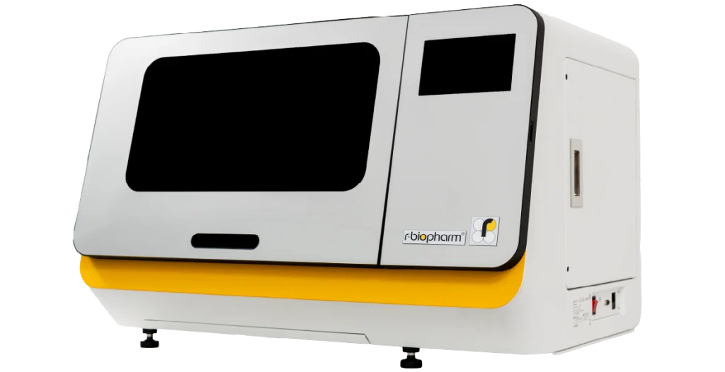 A RIDA®Xtract 24 instrument on an oblique angle. Large, rectangular piece of equipment with a white facade, yellow base and two dark glass screens