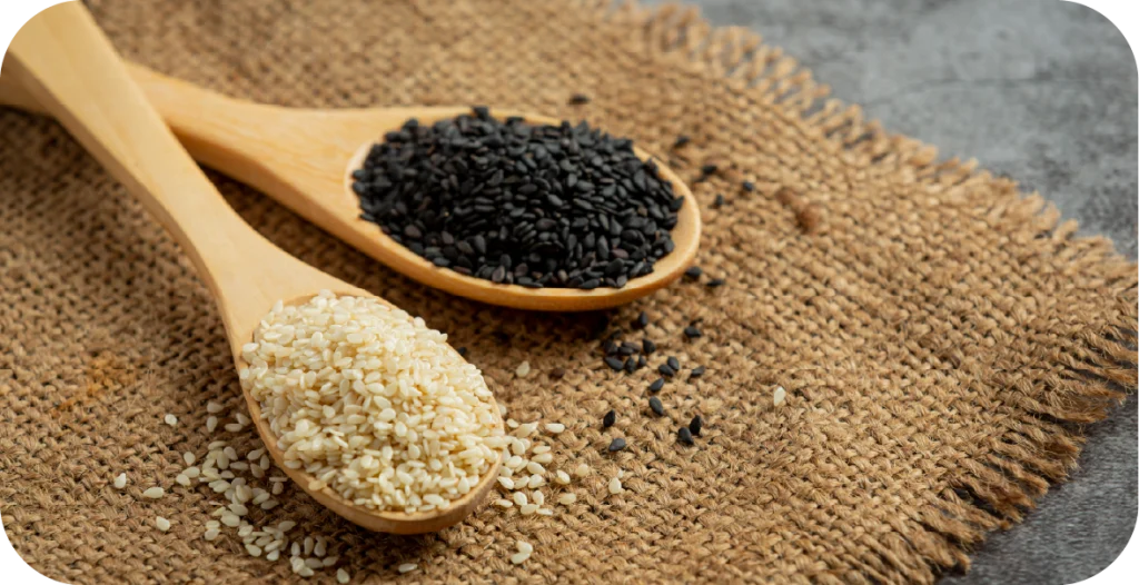 White and black sesame seeds on wooden spoons, sitting on a hessian bag. R-Biopharm offers a suite of assays for sesame testing