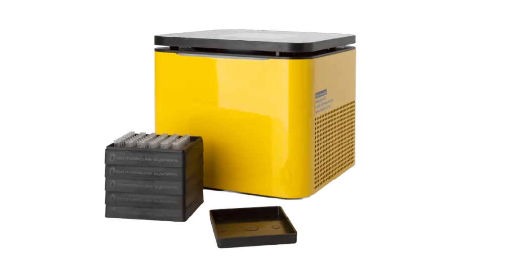 A small yellow box with a black lid sits behind a cassette tray and its lid
