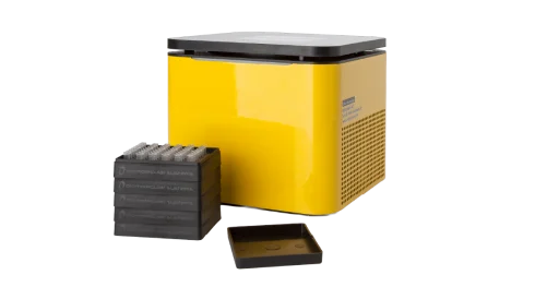 A small yellow box with a black lid sits behind a cassette tray and its lid
