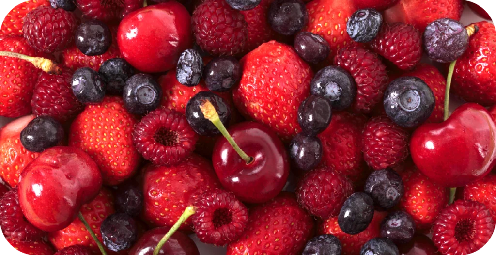 a close up of mixed berries, including raspberries, blueberries and cherries