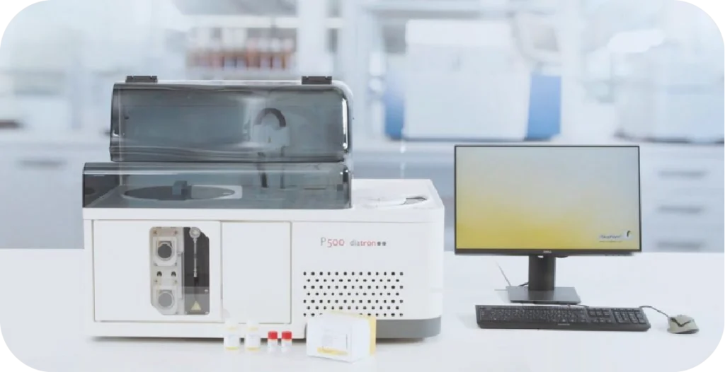 The Pictus 500, a large rectangular white box with a dark clear plastic lid next to a computer with results