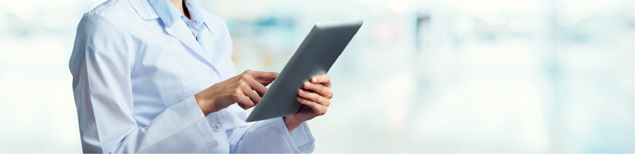 a scientist holds a tablet in a laboratory