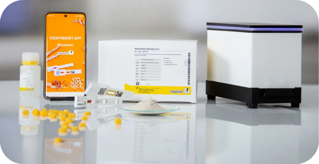 a phone, components and piece of diagnostic equipment displayed on a bench alongside food